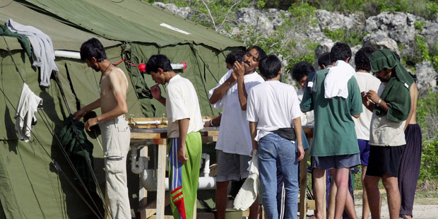 Men shave, brush their teeth and prepare for the day at a refugee camp on the Island of Nauru. Photo / AP
