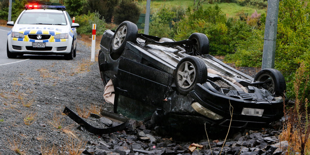 Wet weather created difficult driving conditions around Northland, resulting in several crashes. A car rolled upside down on Puna Rere Drive. Photo / John Stone