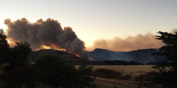 Plumes of smoke billow from fires in Christchurch's Port Hills this morning. Photo / Joshua Price