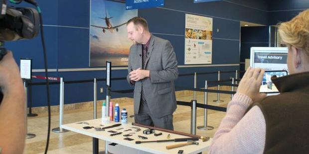 TSA spokesman Mark Howell with the sword and other confiscated items. Photo / Facebook