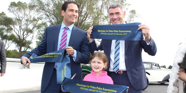 Transport Minister Simon Bridges, Otaki MP Nathan Guy, and Waikanae girl Grace Ahern, 6, after cutting a ribbon to mark the completion of the Mackays to Peka Peka Expressway. Photo / David Haxton