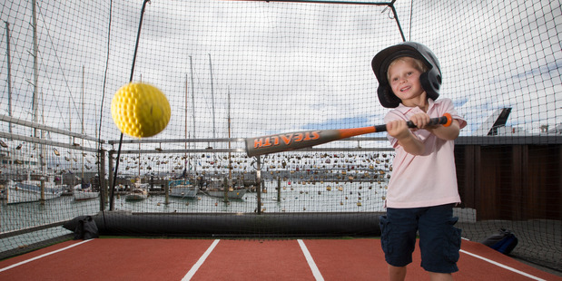 Ryder Beard, 4, takes a swing in the baseball batting cage set up in Wynyard Quarter. Photo / Nick Reed