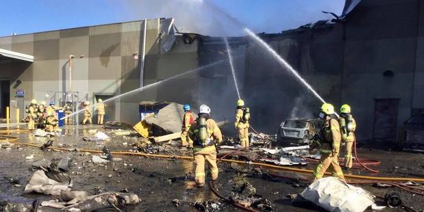 Firefighters work to douse flames after the aircraft crashed into a section of the DFO shopping complex at Essendon. Photo / Melbourne Metropolitan Fire Brigade
