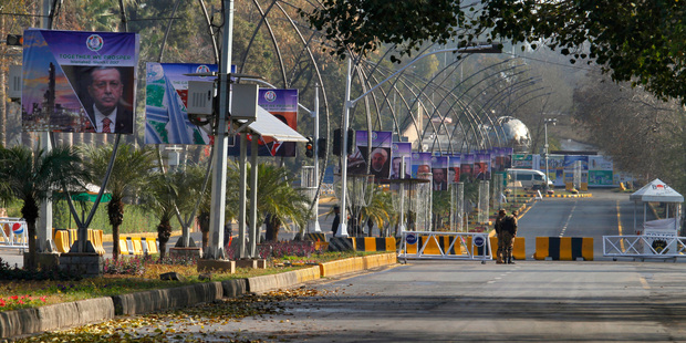Pakistani Army soldiers stand guard at a barricaded road leading to the venue of the Economic Cooperation Organisation summit in Islamabad, Pakistan. Photo / AP