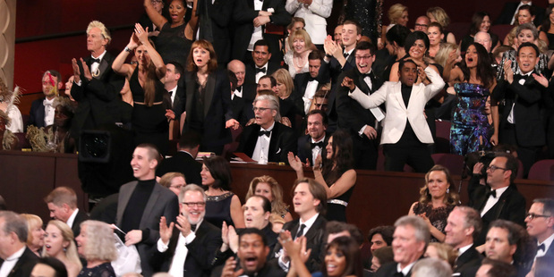 The cast of Moonlight celebrates as Moonlight wins the best picture award at the Oscars after La La Land was incorrectly named the winner. Photo/AP