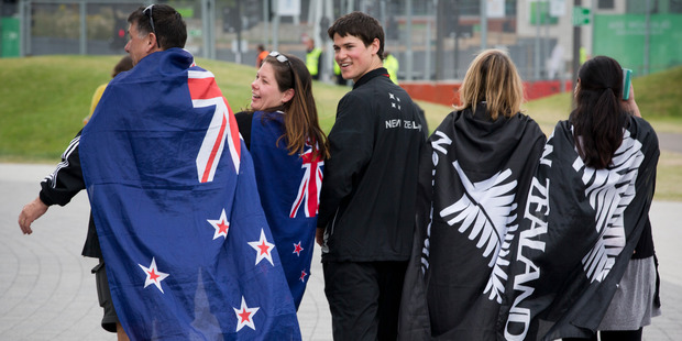 New Zealand gymnast David Bishop (centre), with his family draped in flags, after winning a bronze medal in the floor competition at the XX Commonwealth Games in Glasgow. Photo /Greg Bowker