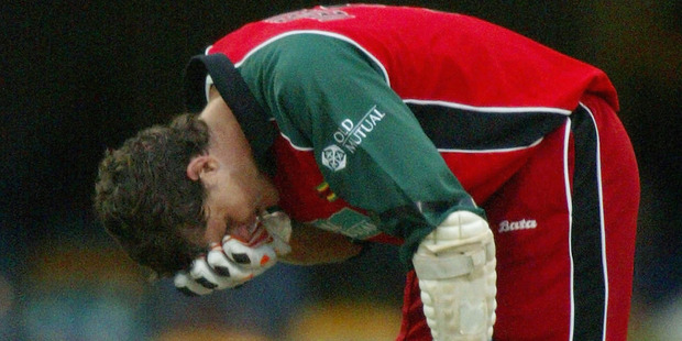 Mark Vermeulen of Zimbabwe shows his discomfort after being struck by the ball against India. Photo/Getty Images