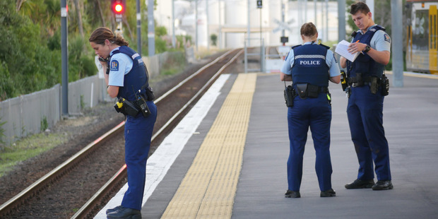 Police stand guard where a woman was trapped between a moving train and the station platform at Glen Innes train station, Auckland. Photo / Steven McNicholl