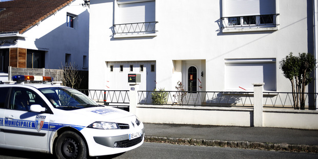 A police car parked outside the house belonging to the missing Troadec family. Photo / AP