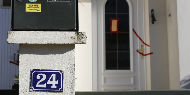 The entrance and mailbox, sealed by police, of the house belonging to the missing Troadec family in Orvault,. Photo / AP