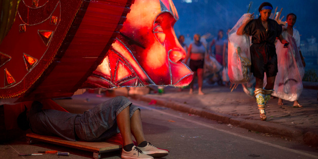 A man works on a float prior the start of Carnival celebrations at the Sambadrome in Rio de Janeiro. Photo / AP