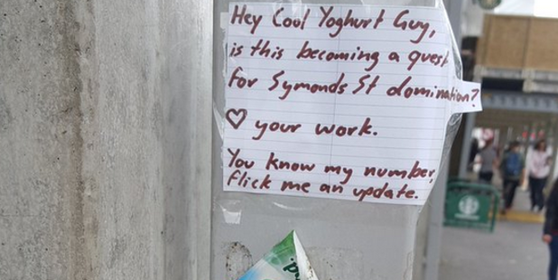 Cool Yoghurt Guy this morning left a yoghurt lid on the window of Gordon Harris and on a pole on Symonds St directly across from the shop. Photo / Amelia Petrovich (@AmeliaPetrovich) via Twitter