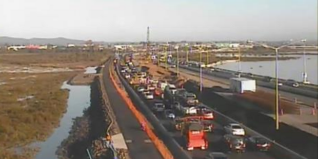 Traffic is heavy on the Northwestern Motorway after a truck rolled. Photo / NZ Transport Agency