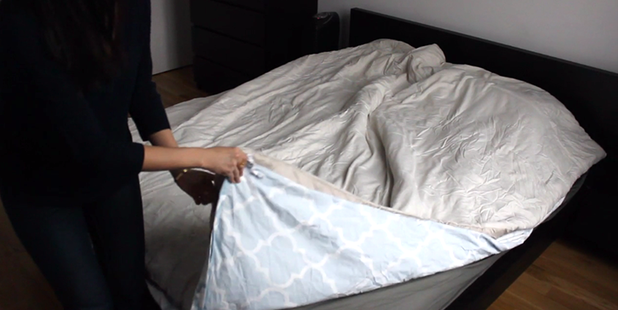 Lay you comforter on top of your duvet cover, making sure all four corners match. Photo / Inhabitat YouTube