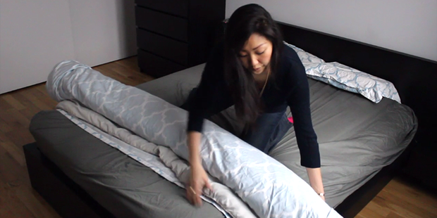 Inhabitat editor Yuka Yoneda credits her "burrito" method as making the process of changing a duvet cover much easier. Photo / Inhabitat YouTube