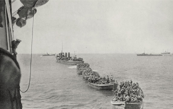 The landing. Auckland troops many of whom were shot by the enemy before the landing at Gaba Tepe, being towed by a destroyer from the troopship Ludzow to the shores of Gallipoli. | 08 July 1915 Weekly News