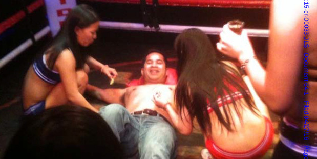 Navy Cmdr. Michael Misiewicz, center, lies flat on his back in a boxing ring during 'Fight Night' at a Manila nightclub. He said Francis mentored him and acted like a big brother. Photo / Supplied
