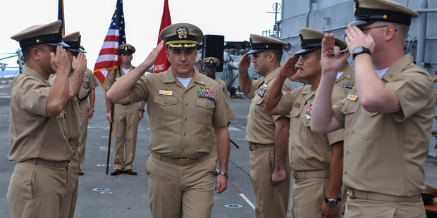 U.S. Navy Capt. Daniel Dusek, center, handed over classified ship schedules and steered aircraft carriers to "fat revenue ports" controlled by Glenn Defense. Photo / The Washington Post