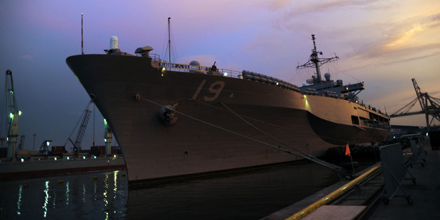 The sun sets behind the USS Blue Ridge, the flagship for the Navy's 7th Fleet. Photo / The Washington Post