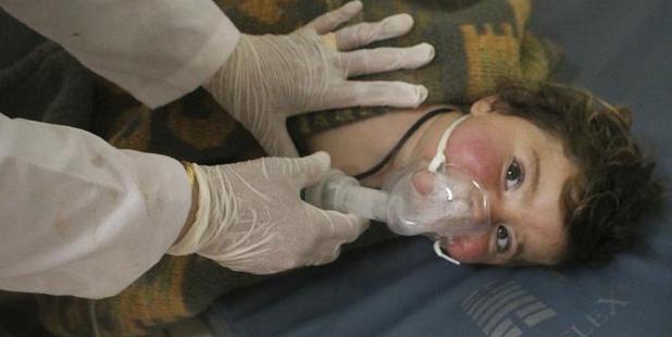  Syrian doctor treats a child at a makeshift hospital following the suspected attack. Photo / AP