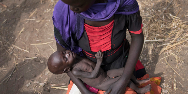 Adel Bol, 20, cradles her 10-month-old daughter Akir Mayen at a food distribution site in Malualkuel, South Sudan. Photo / AP