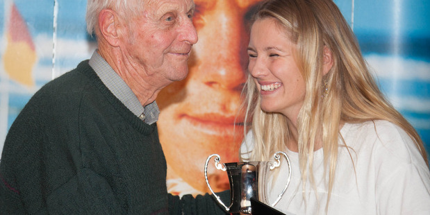 Otaki Surf Life Saving Club member Sophrose London is presented with the U19 Lifeguard of the Year title from Paekakariki Surf Life Saving Club life member Joost Brinck. Photo: Jamie Nilsson
