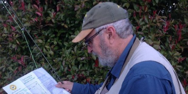 Murray Cullen from Australia, consulting the new Tongariro River Bucket List fishing map.