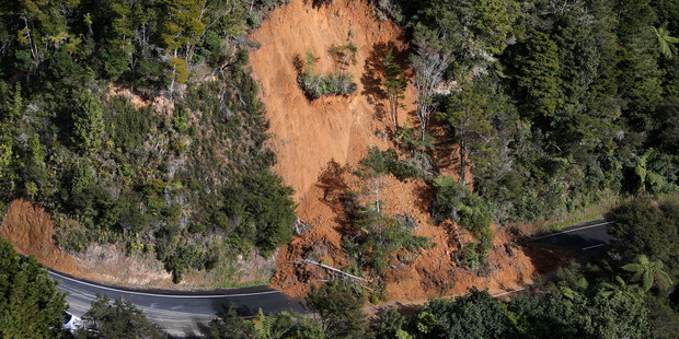 The latest slip on Helena Bay Hill spewed across the road but has been partially cleared by a local on a digger that allowed traffic through one lane. Photo/Michael Cunningham