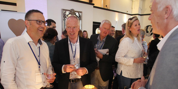 Jason Forbes (left), Phil Teague and Tony Bish offering the Tony Bish Arts Collective for the Hawke's Bay Wine Auction at the pre-tasting event in Napier last night. Photo/Duncan Brown.