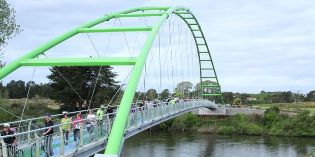 The first cyclists and walkers on the Perry Bridge after it was opened on Thursday at Horotiu. The bridge will offer a connection between the future Te Awa Lakes development site and the Te Awa Cycleway. Photo / Tom Rowland