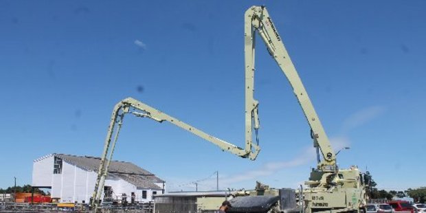 Pouring a fluid to make the concrete flow