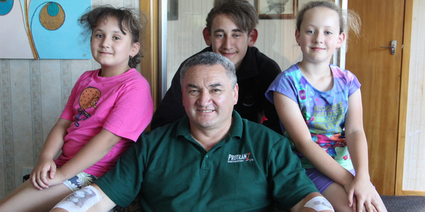 Lee Rogers is home with his family, to the relief of his children, from left, Maddison, Jordan and Abby. Photo / Ilona Hanne