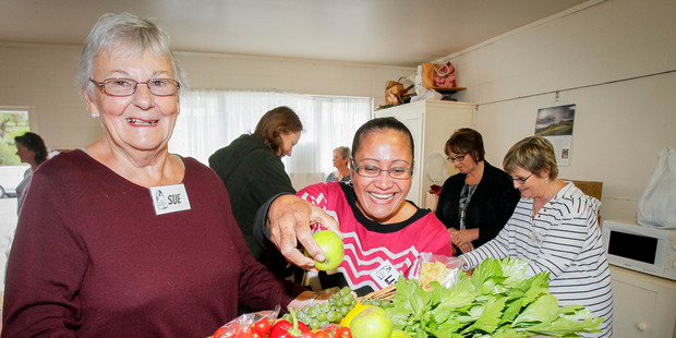 Sue Smith and Lisi Neemia, volunteers with CHB food rescue group The Food Basket, inspect the fruit and veg at the group's first session at Waipawa Senior Citizens Building last Tuesday.