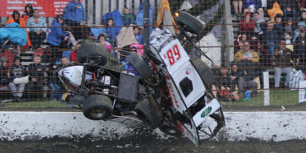 Daryl Hughes and Chris Bagrie somersault through the air after rain fell during racing at Stratford Speedway on Boxing Night.