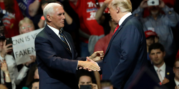 Vice-President Mike Pence (left) greets President Donald Trump onstage during a Republican campaign rally. Photo / Getty Images