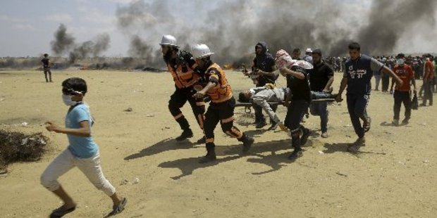 Palestinian medics and protesters evacuate a wounded youth during a protest at the Gaza Strip's border with Israel. Photo / File