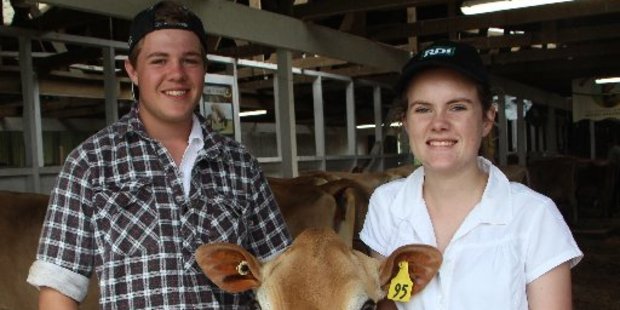 Cousins Sam Johnson and Ashleigh Stanners with Jane the cow. The cousins are the third generation to be interested in jersey breeding from the Johnson family.