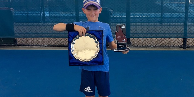 Cody Atkinson after winning the singles and doubles at the Rod Laver national 10 and under boys tournament. The plate is for the doubles and the Queensland shaped trophy for the singles.