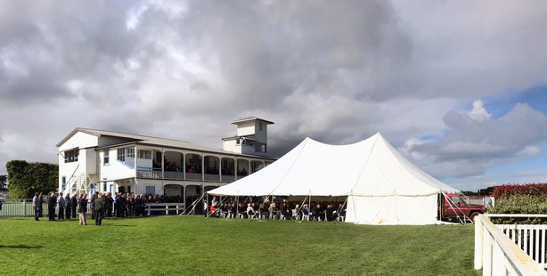 Mourners pack the marquee and birdcage at the Waverley racecouse during John Alexander's farewell service.