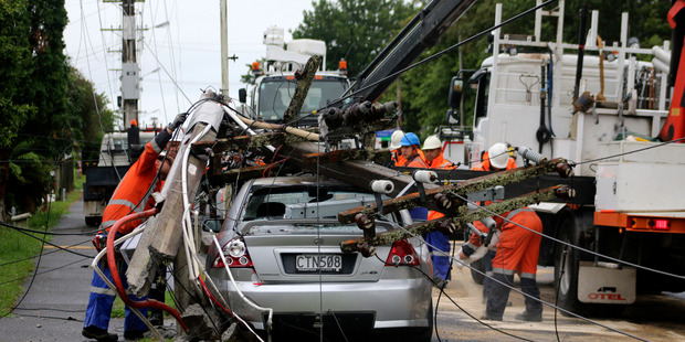 Waipa Networks linesmen extricate the Holden from the smashed pole.