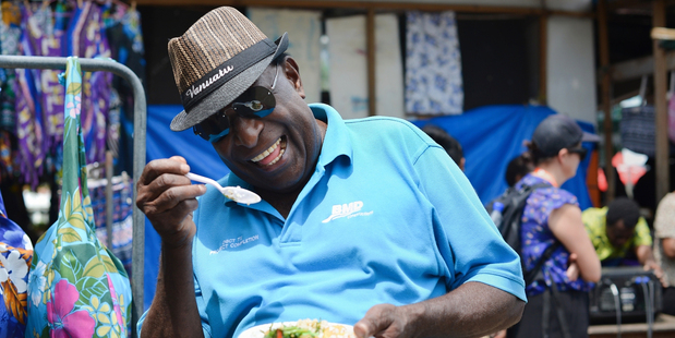 Diners at the Vila market share lunch. Photo / Chris Tarpey
