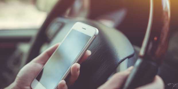 The officer was caught using her phone while driving. Photo / 123RF