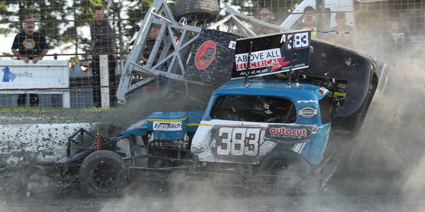 Auckland driver Gary Lonergan launches Lawrence Barr up the wall during teams racing at Stratford Speedway.