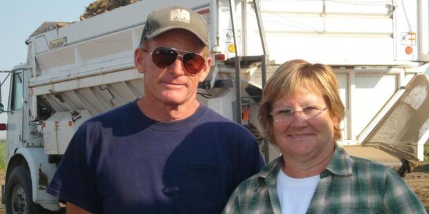 John and Meredith McLeod cover up during their potato harvest due to the sun and heat. Photo / Supplied