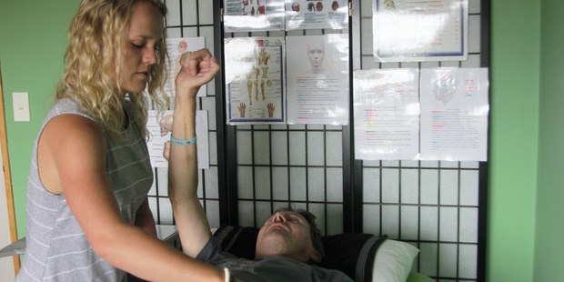 Te Awamutu's Paige West practising muscle testing on her father Steve "Stubby" West.