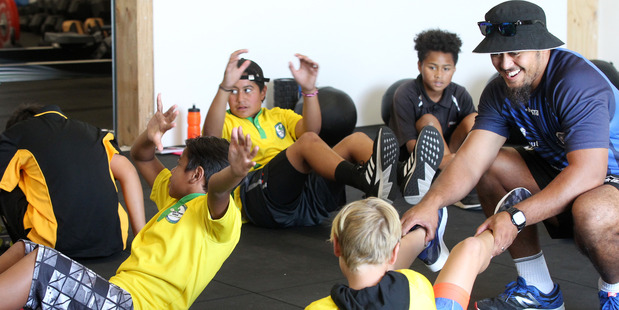Timo Vaiusu, teacher, Kimi Ora Community School, helps pupils on the first day of the Flaxmere Schools' Sports Academy at the Hawke's Bay Community Fitness Centre Trust in Hastings. Photo/Duncan Brown