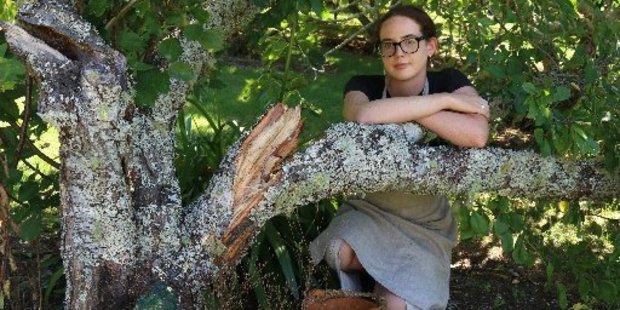 Kerikeri Mission Station visitor host Harriet Barker-Reid with a plum tree stripped of fruit and broken by thieves.